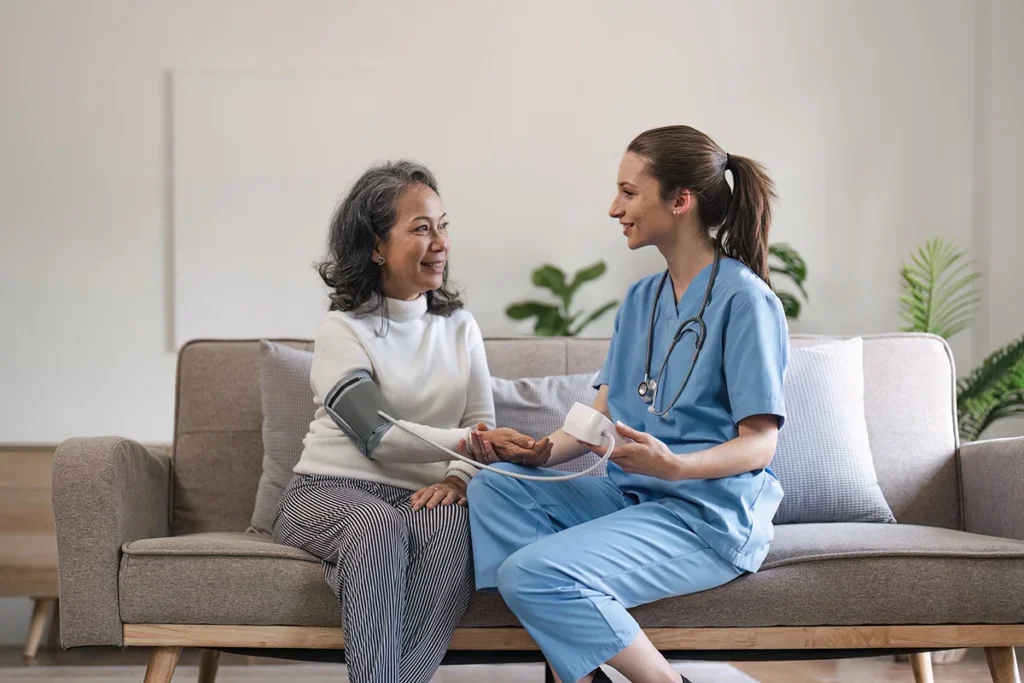 female doctor checks senior woman s blood pressure