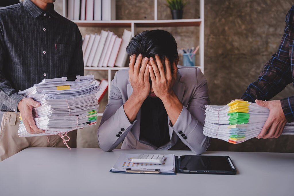 overwhelmed business professional with too much