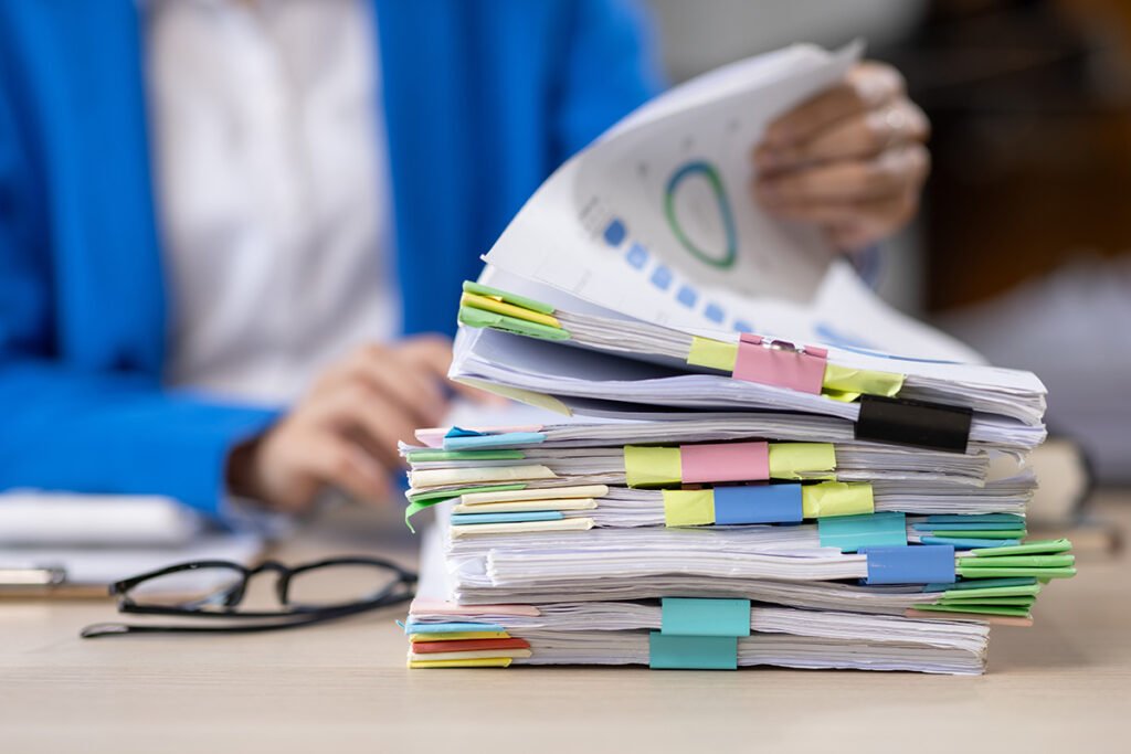 stack of documents and businesswoman