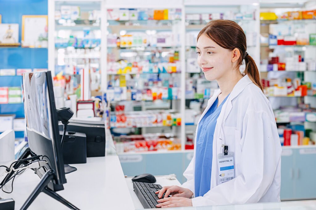 woman working at computer in hospital pharmacy